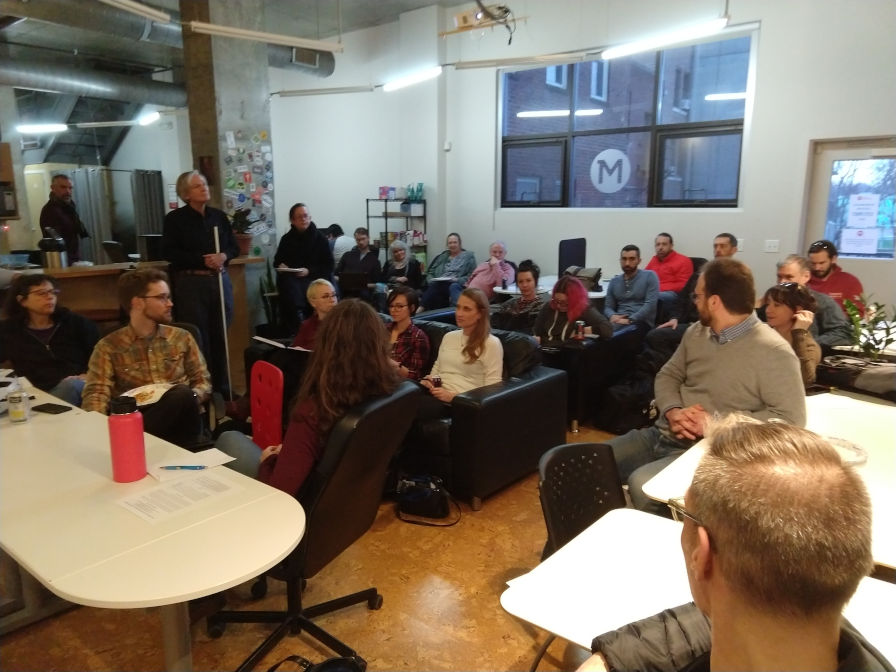 Group of people listening to a WordPress Meetup talk.
